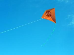 an orange kite flying in the sky at Chalet confortable avec terrasse - API-1-52-1104 in Charmes-sur-lʼHerbasse