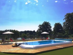 a large swimming pool with a metal railing around it at Mobil-home cosy avec terrasse à Loudéac - API-1-52-1116 in Loudéac