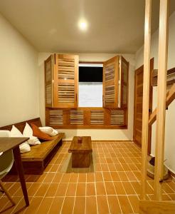 a living room with a bed and a window at Cabañas Las Camelias in Cuetzalán del Progreso
