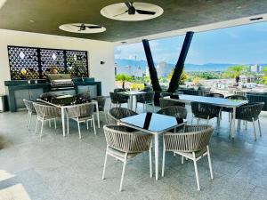 a restaurant with tables and chairs and a large window at Luxury Condo en Nuevo Vallarta Alberca Tipo Resort in Nuevo Vallarta