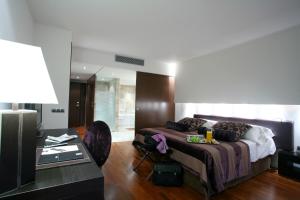 a hotel room with a bed and a desk at Finca Prats Hotel Golf & Spa in Lleida
