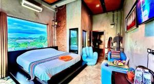 a bedroom with a large bed and a large window at Theloft boutique nakhonpanom in Ban Noi Pho Kham