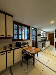 a large kitchen with a wooden table and a table at Tribo Rio in Rio de Janeiro