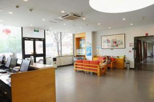 a waiting room with couches and chairs in a building at 7 Days Premium Beijing Dabaotai Metro Station Luhua Road in Beijing