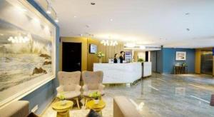 um lobby de hotel com balcão de recepção em Metropolo Hotel Qingdao Wusi Square Xiaomaidao em Qingdao