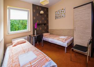 Postel nebo postele na pokoji v ubytování Hotelik Jankowski