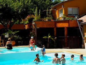 a group of children playing in a swimming pool at Gîte confortable avec terrasse à Salavas - API-1-52-1143 in Vallon-Pont-dʼArc