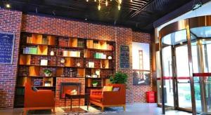 a brick wall with a fireplace in a library at James Joyce Coffetel Guangyuan High-Speed Railway Station Dongba Municipal Government in Guangyuan