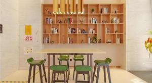 a table with four green stools in a room at City Comfort Inn Taizhou International Exhibition Center in Ma-pu-ch'iao