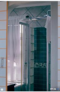 a bathroom with a shower with a mirror and a sink at ikhaya in Port Edward