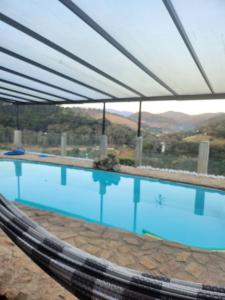 Swimmingpoolen hos eller tæt på Suítes Sonhos e Requinte