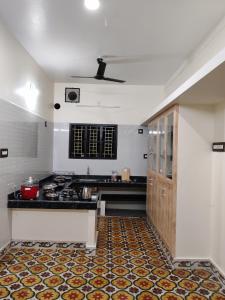 a kitchen with a stove and a counter top at The Sparrow House 2BHK Ground Floor in Kumbakonam
