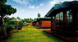 a house with a grass yard next to a building at Ma-Oya Retreat in Andiramada