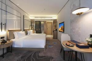 Giường trong phòng chung tại Shenzhen Apex Hotel (Technology Park Branch)