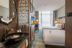 Postel nebo postele na pokoji v ubytování Shenzhen Apex Hotel (Technology Park Branch)