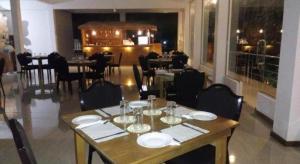 a dining room with a table with plates and wine glasses at Ma-Oya Retreat in Andiramada