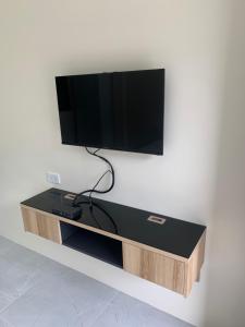 a flat screen tv hanging on a wall at ZAMZAM House in Thalang