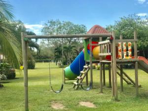 a playground in a park with a swing at Yopo Resort in Yopal