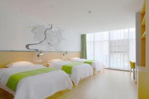 Postel nebo postele na pokoji v ubytování Vatica Hotel Hefei Yaohai Longgang Subway Station + 179 fotografií