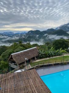 a view of a resort with a swimming pool and mountains at Hotel Monte Ixk'al Xilitla in Xilitla