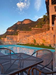 Una mesa y sillas junto a una piscina. en Hotel Monte Ixk'al Xilitla, en Xilitla