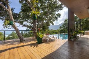 a wooden deck with a tree on top of a house at Escape Villa 2-Bedroom Luxury Retreat with Private Pool & Sea View in Mae Haad
