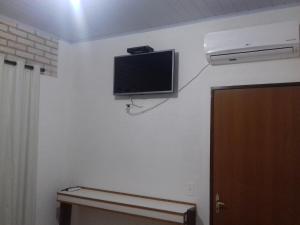 a flat screen tv on the wall of a room at Pouso D' Braga in Pirenópolis
