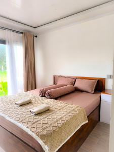 Ένα ή περισσότερα κρεβάτια σε δωμάτιο στο Swarga Rinjani