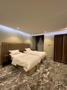 two beds in a hotel room with at Bright Star Hotel in AlUla