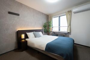 Ένα ή περισσότερα κρεβάτια σε δωμάτιο στο Residence Hotel Sapporo Susukino +22 φωτογραφίες