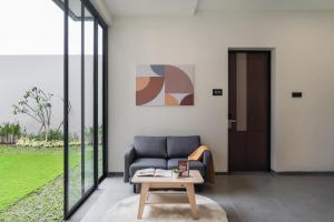 ein Wohnzimmer mit Sofa und Tisch in der Unterkunft Cove Legacy in Jakarta