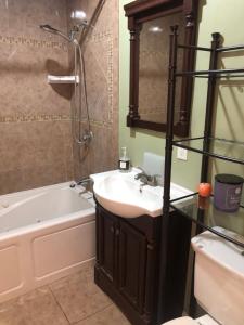 The Corner Suite في نورووك: حمام مع مغسلة وحوض استحمام