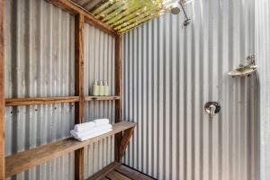 a room with a metal wall with a shelf and a door at Hidden Zen - A South Freo Retreat in South Fremantle +34 photos