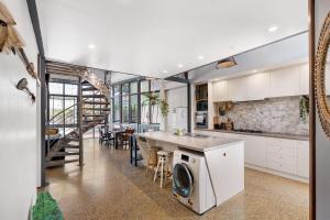 a kitchen with a washer and dryer on a counter at Hidden Zen - A South Freo Retreat in South Fremantle
