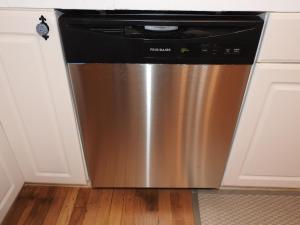 a stainless steel dishwasher in a kitchen with white cabinets at Miners Choice 3 Bedroom on Main St Bonus Rooms Sleeps up to 9 TV WIFI Piano in Julian