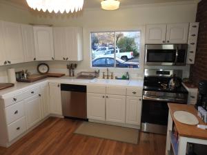 a kitchen with white cabinets and a sink and a window at Miners Choice 3 Bedroom on Main St Bonus Rooms Sleeps up to 9 TV WIFI Piano in Julian