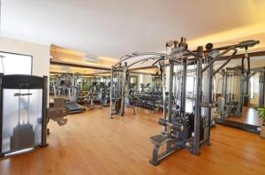 a gym with several tread machines in a room at The Axana Hotel in Kampungdurian