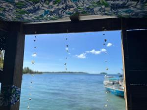 波拉波拉Bora Roots Camp的享有水景和船景的窗户