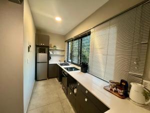 a kitchen with a counter and a large window at Stay on Main 1 in Paarl
