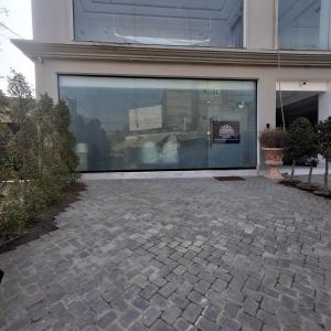 a large glass door of a building with a patio at Regency Suites in Lahore