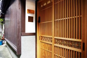 a wooden door with a wooden paneled door sidx sidx sidx at Kyoto Senraku in Kyoto