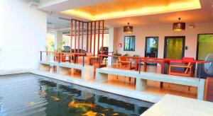 a swimming pool with a koi in a house at The Pride in Sathani Wat Suwan