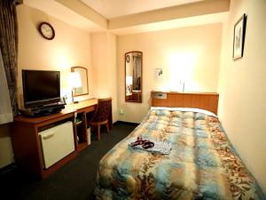 a hotel room with a bed and a desk and a television at Hotel Sun Plaza Sakai in Sakai +17 photos