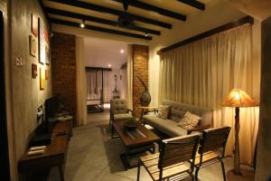 a living room with a couch and a table at The Pines Cottage in Melaka