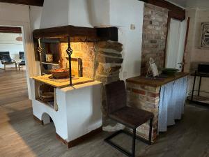 a living room with a stone fireplace with a chair at Jularpscity 