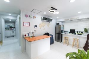 a kitchen with a counter and a refrigerator at Cobe Guesthouse Dongdaemun in Seoul