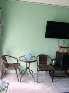 a table with two chairs and a table with a tissue at RATTHANATHON Farm in Khao Kho +8 photos