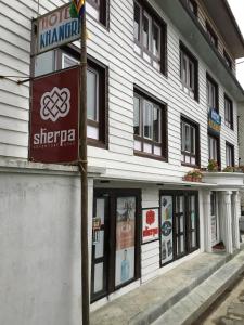 a building with a sign in front of it at Hotel Khangri in Namche