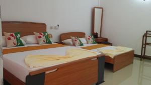 Letto o letti in una camera di Sigiri Regal Residence