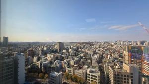 a view of a large city with tall buildings at Paradise Hongdae in Seoul